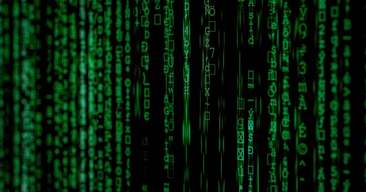 Columns of green computer characters scrolling down a black screen.